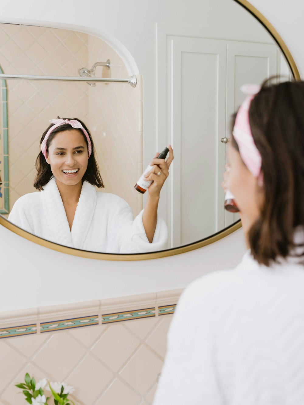 woman in white shirt holding smartphone