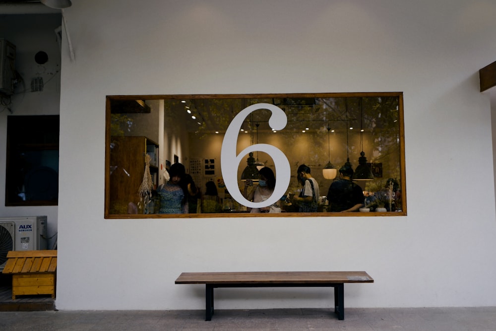 a bench in front of a window with a number 6 on it
