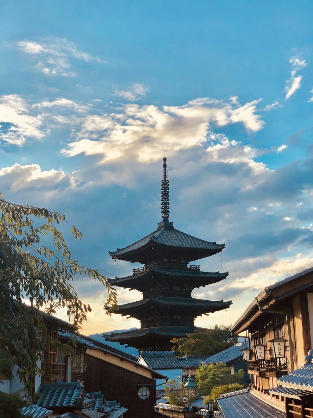 a tall pagoda sitting on top of a lush green field