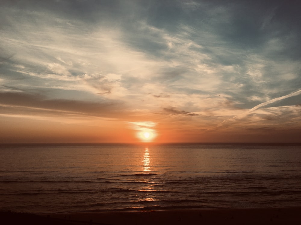 body of water during sunset