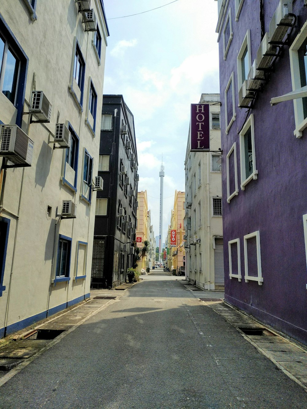 gray concrete road between buildings during daytime