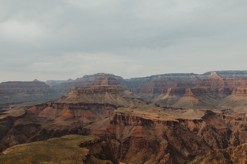 brown rocky mountain under white cloudy sky during daytime