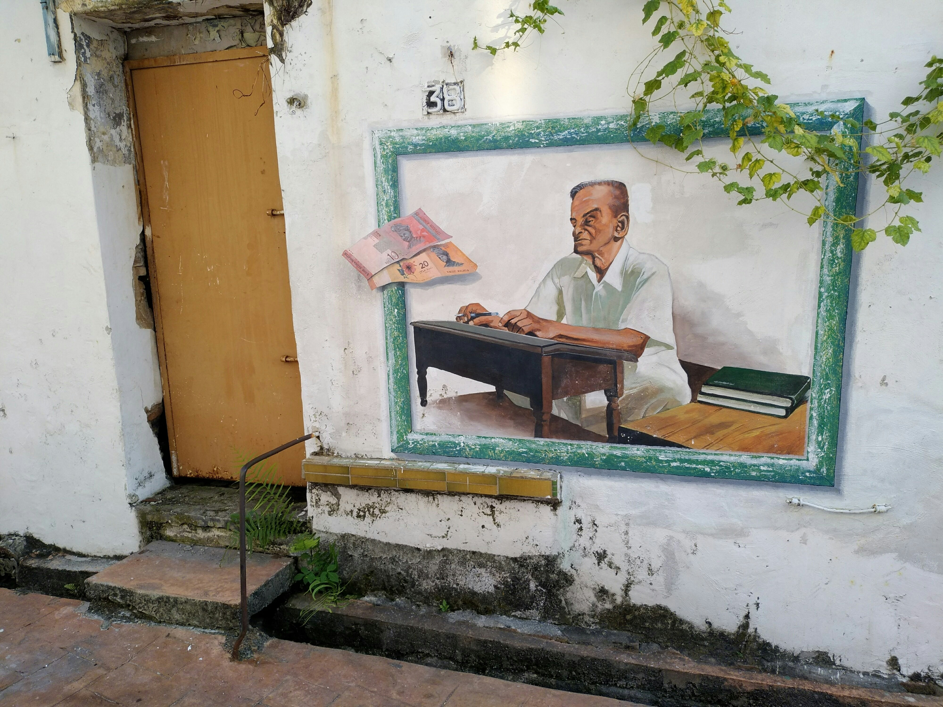 man in white suit sitting on bench
