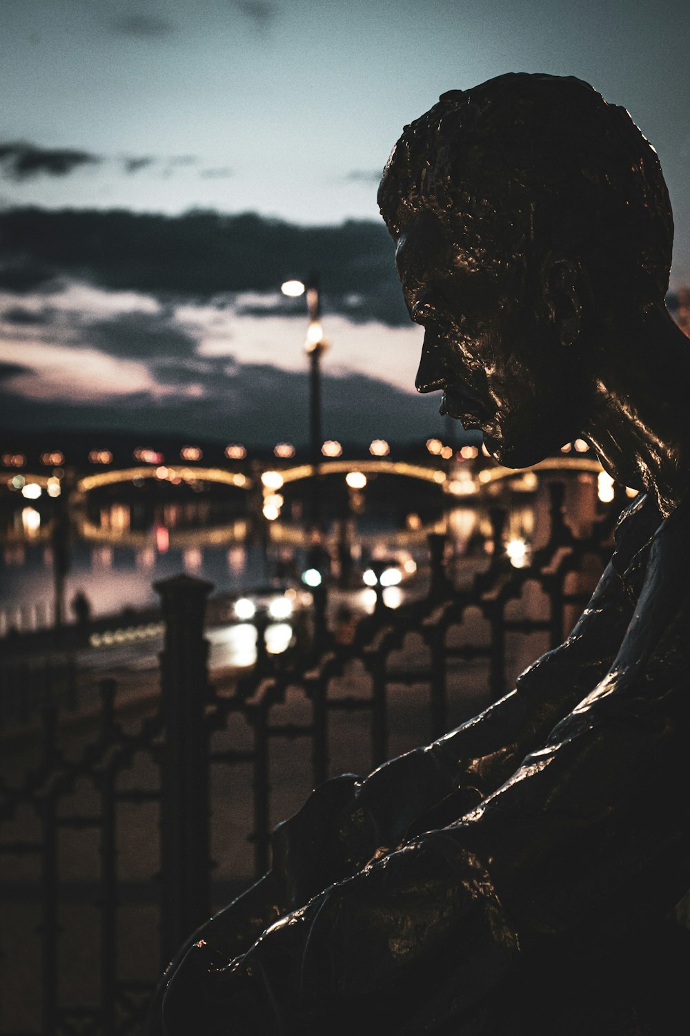 silhouette of woman statue during sunset