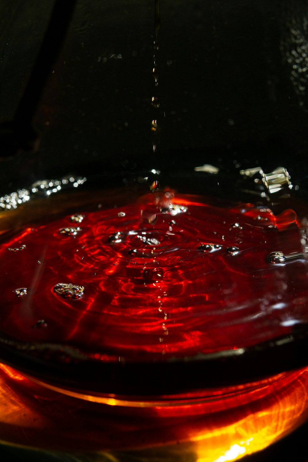 clear glass container with red liquid