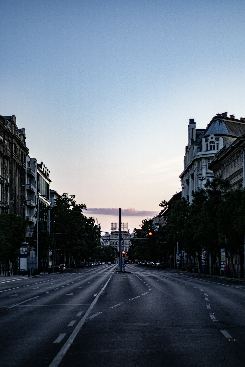 black asphalt road between white concrete buildings during daytime
