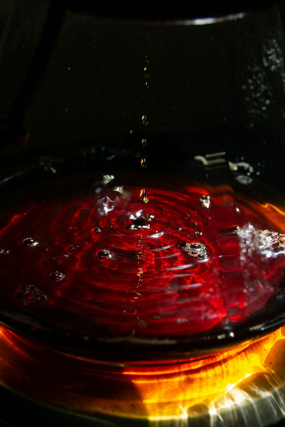 red liquid in clear drinking glass