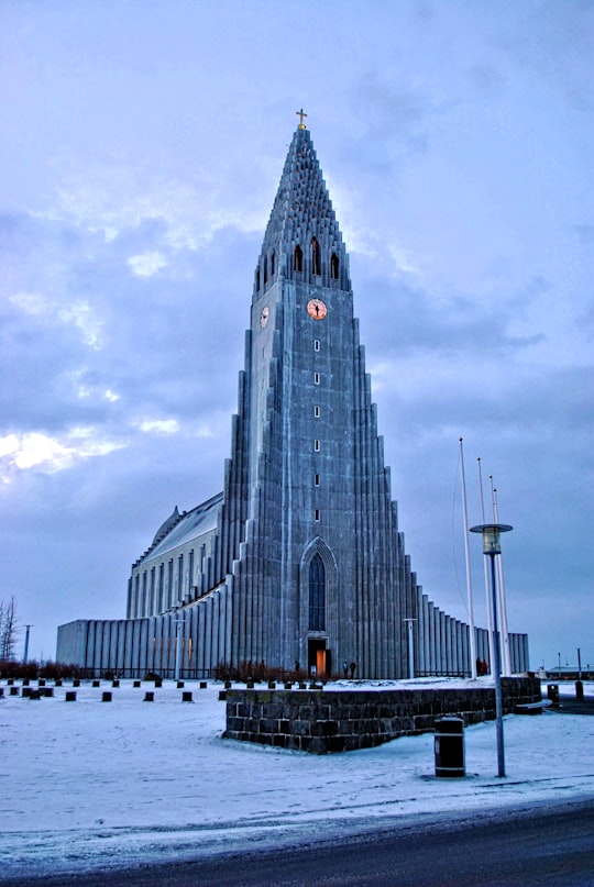 gray concrete building under gray sky during daytime in Hallgrimskirkja Iceland