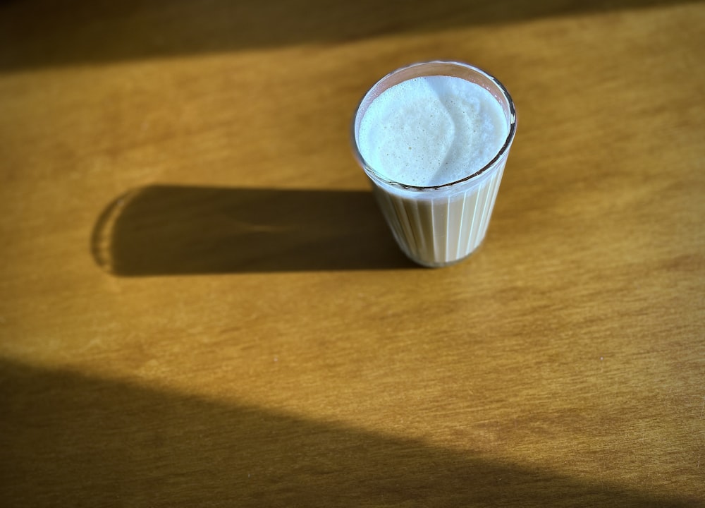 white plastic cup on brown wooden table