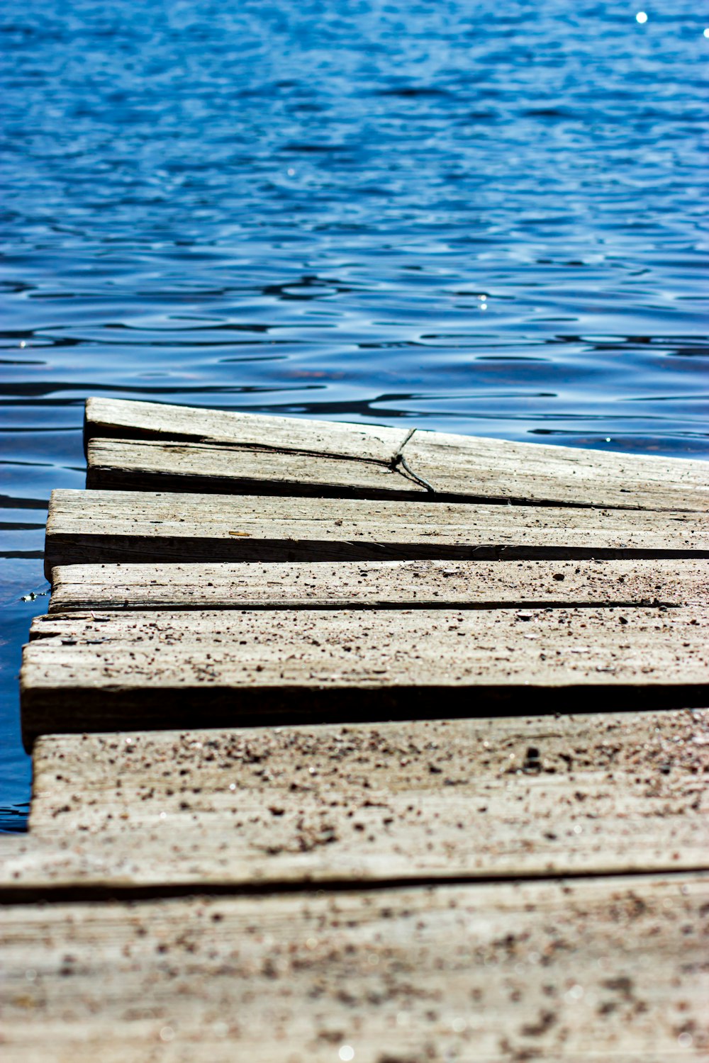 brown wooden dock on water during daytime