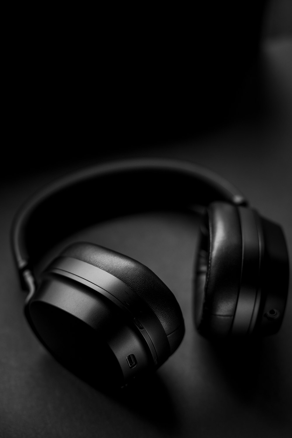 black headphones on black surface