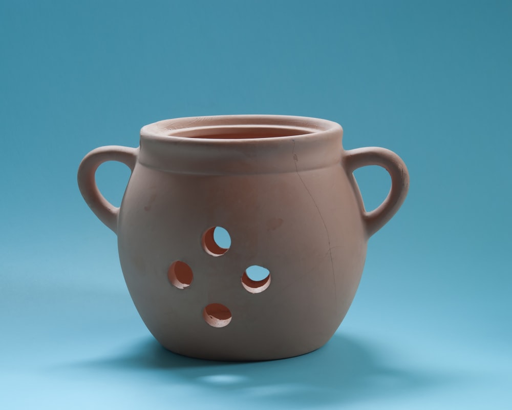 brown ceramic mug on white table