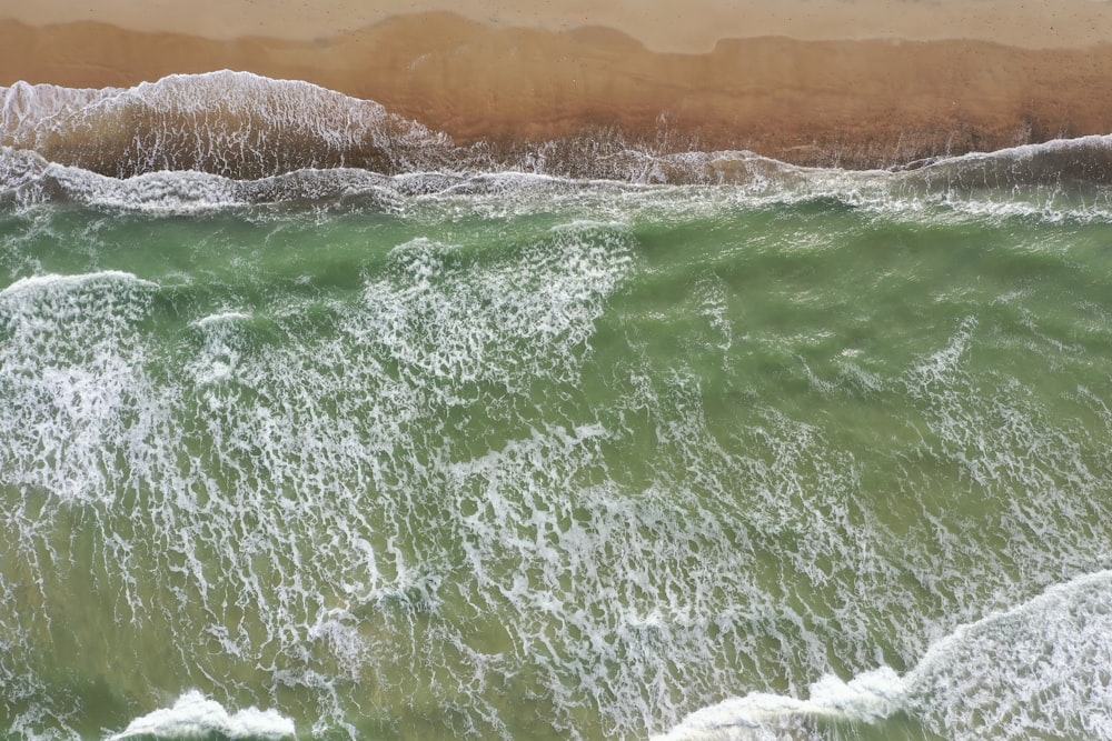 water waves hitting the shore during daytime