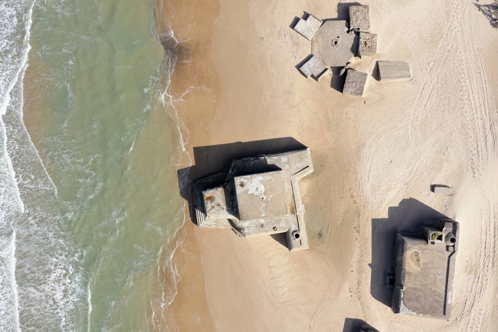 aerial view of gray concrete building near body of water during daytime