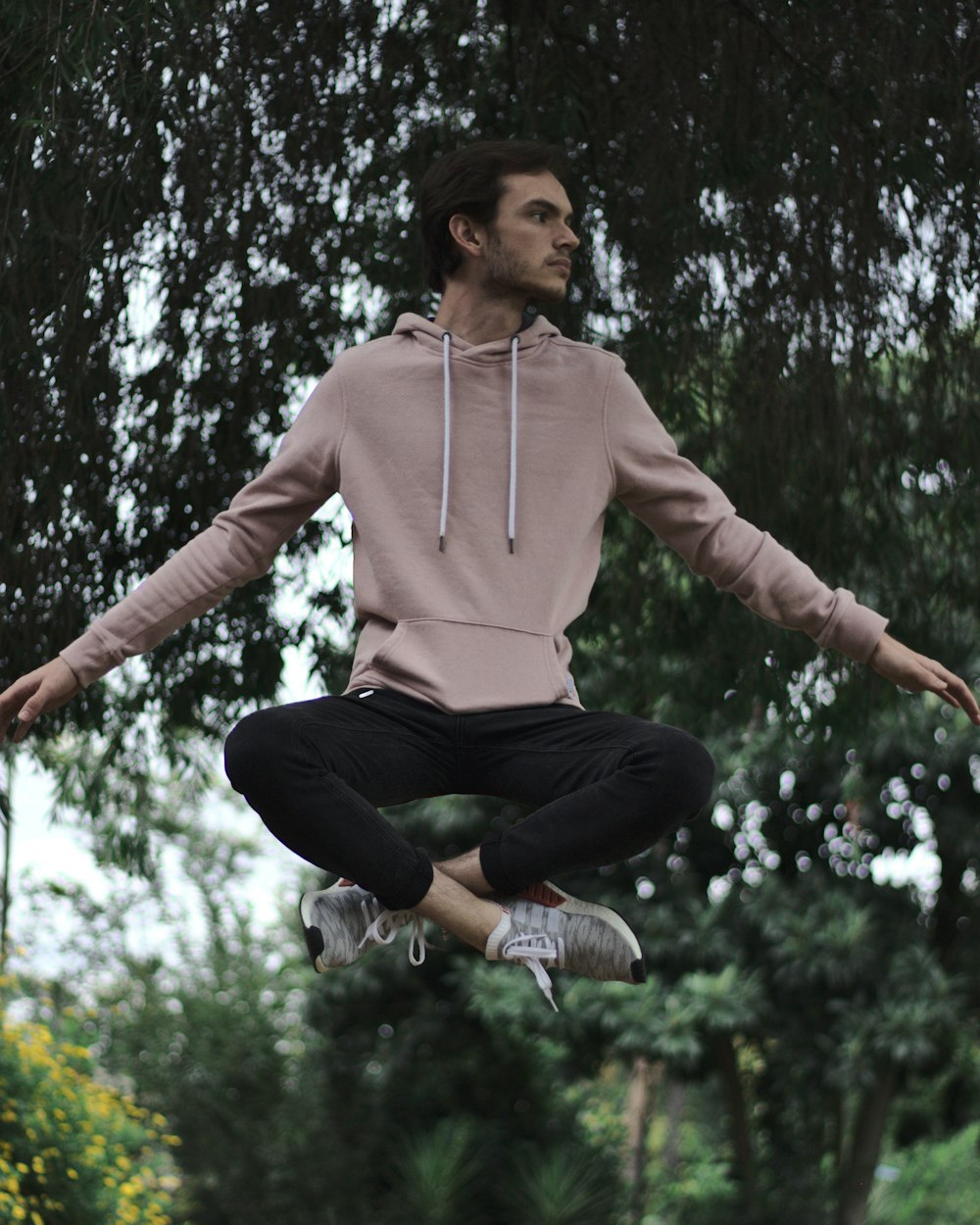 woman in pink hoodie jumping
