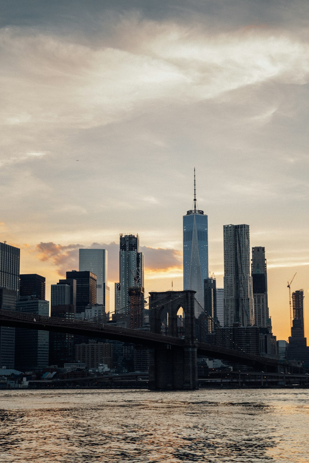 city skyline under white clouds during daytime