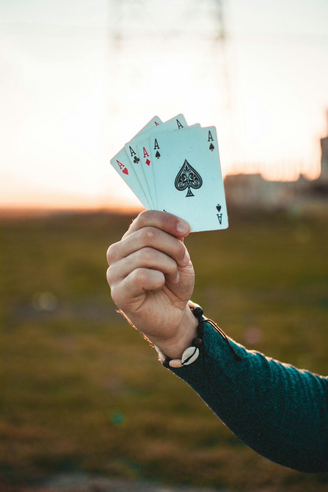 person holding white paper with 2 of spade playing card