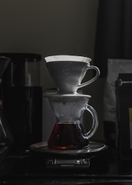 Lifestyle image of someone brewing coffee using a pour-over setup.