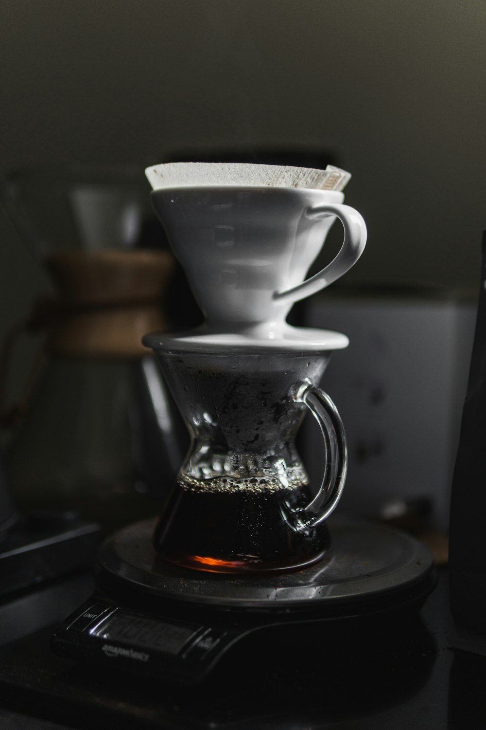 white ceramic cup on black table