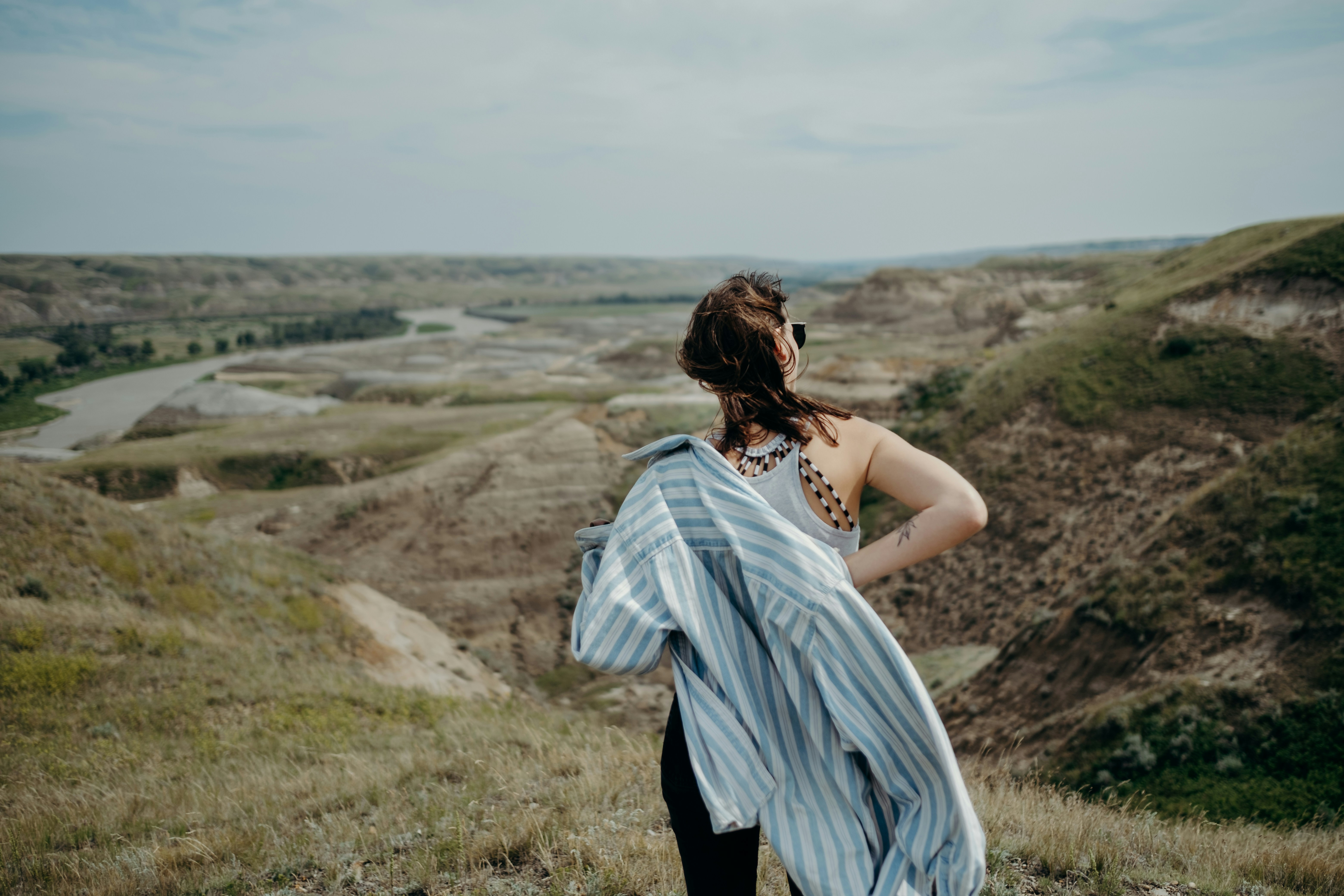 woman in white dress standing on green grass field during daytime