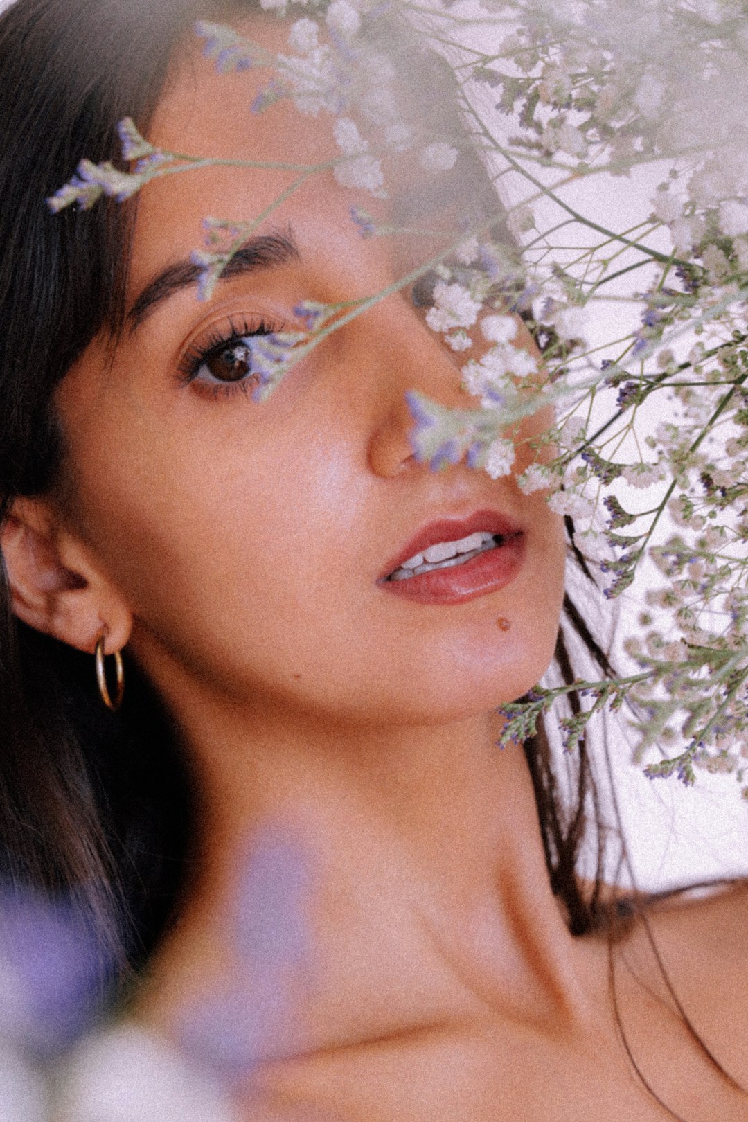 woman with white flower on her ear