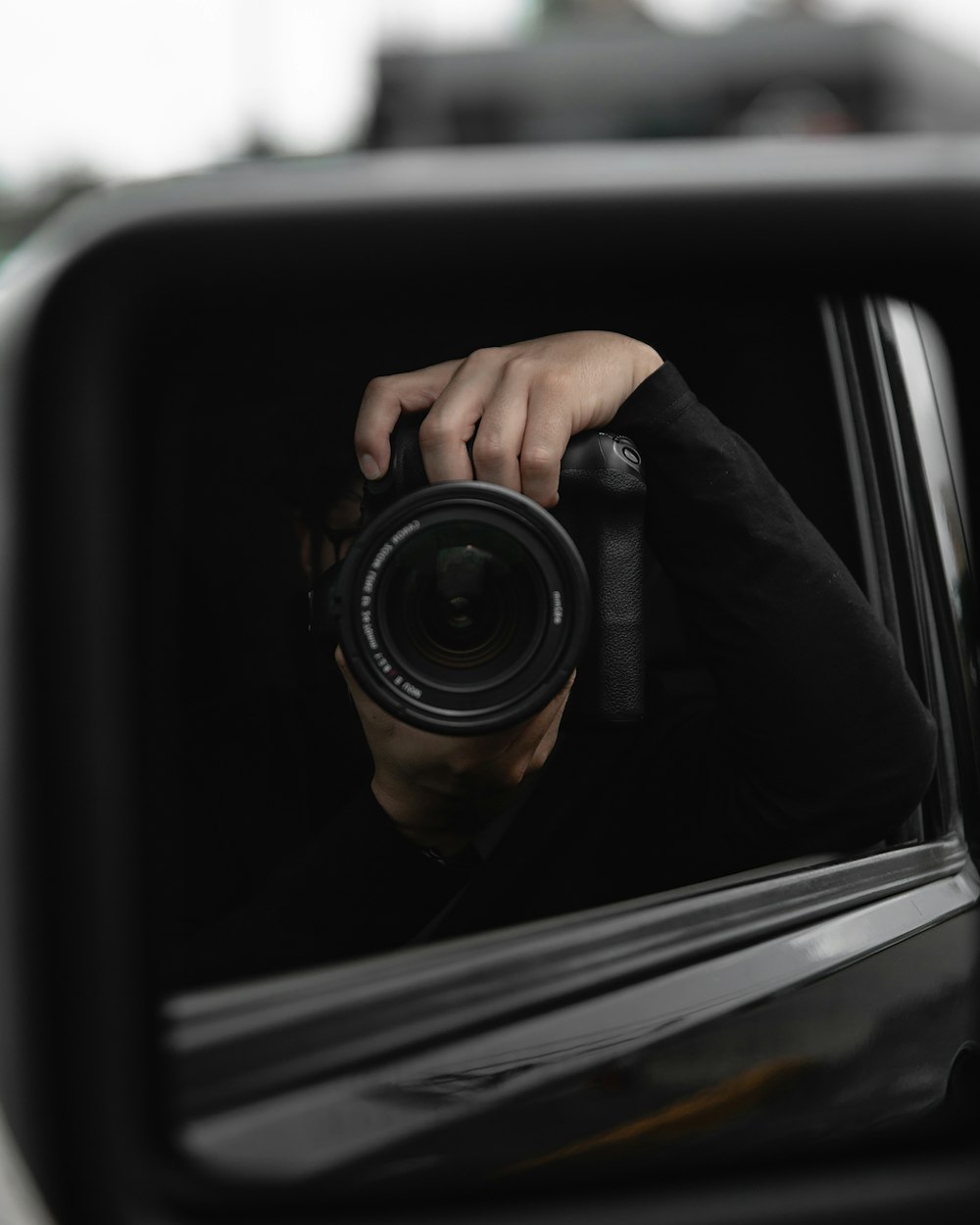 person holding black camera lens