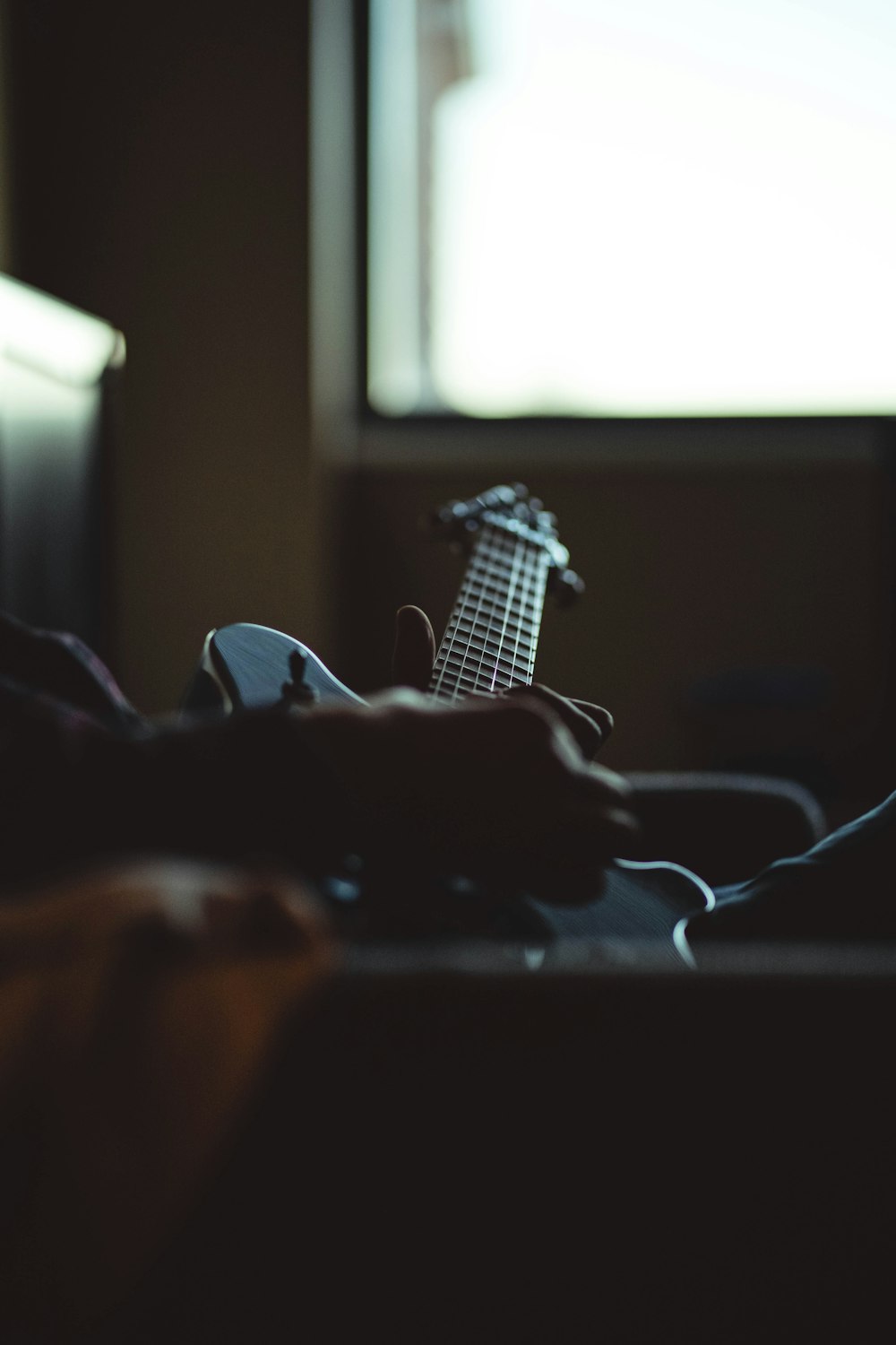 white electric guitar on window