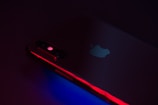 Close-up of a sleek refurbished iPhone with a vibrant screen glowing softly.