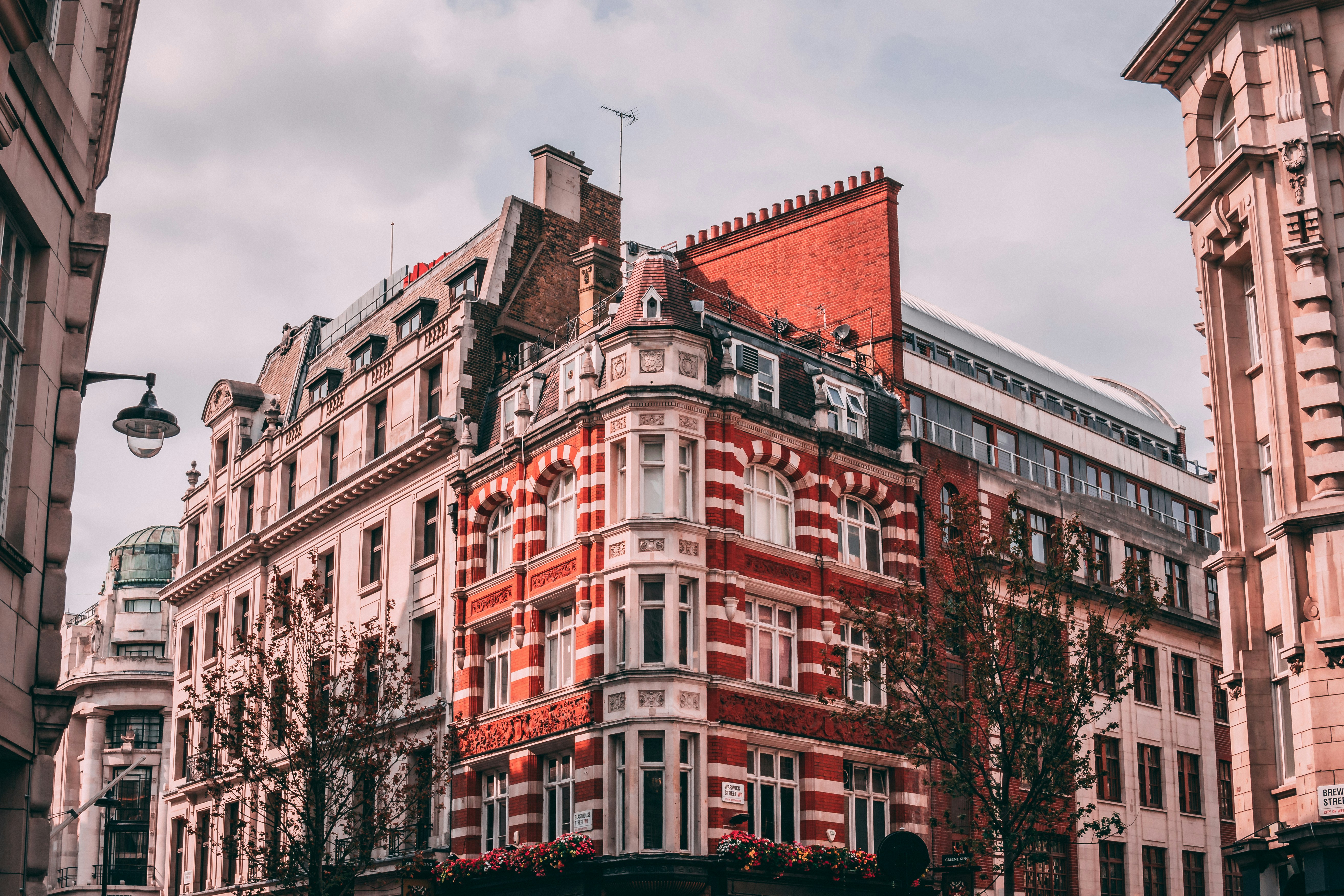 red and white concrete building, Victorian architecture next to Parisian hidden behind the shops of Regent Street.