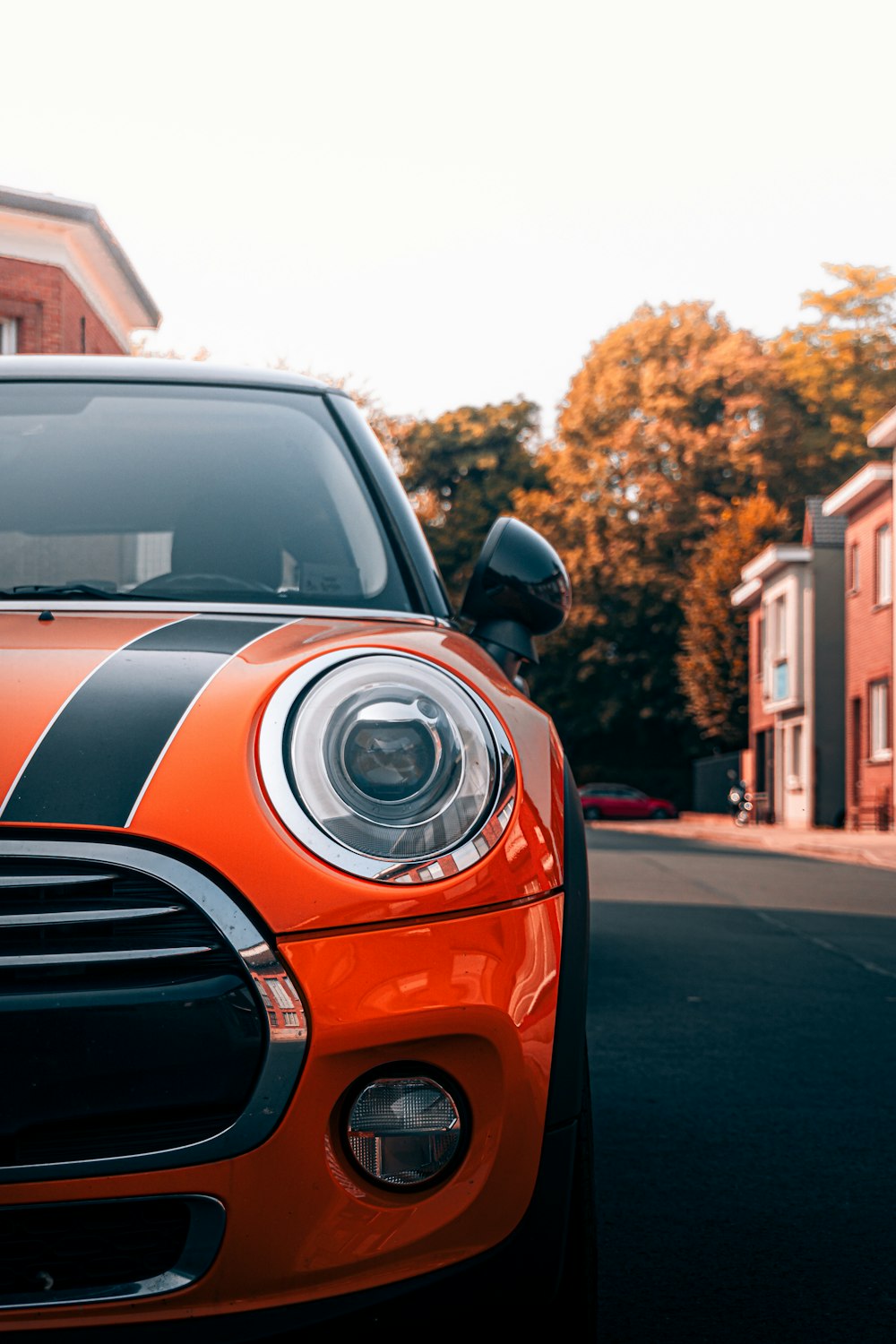 orange and black car on road during daytime