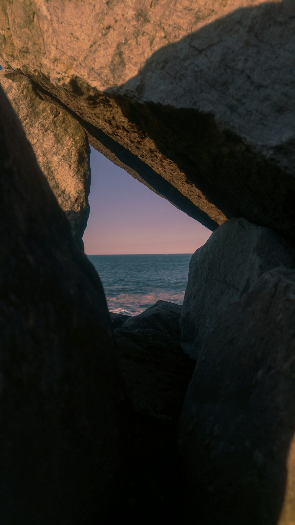 gray rock formation near body of water during daytime