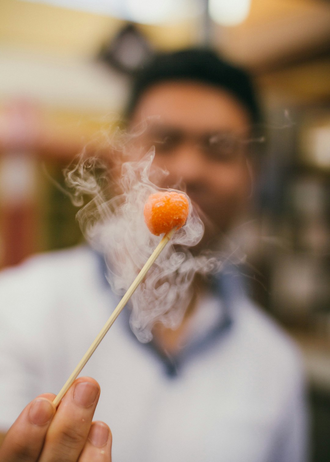  person in white shirt holding white dandelion flower toothpick