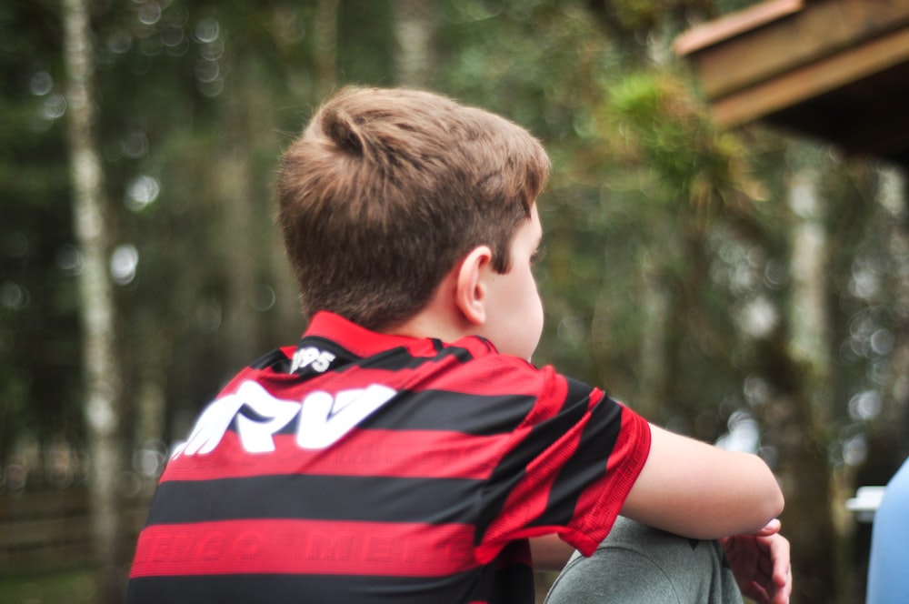 boy in red and black striped shirt