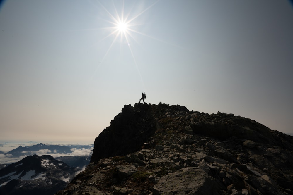 person standing on rock formation during daytime