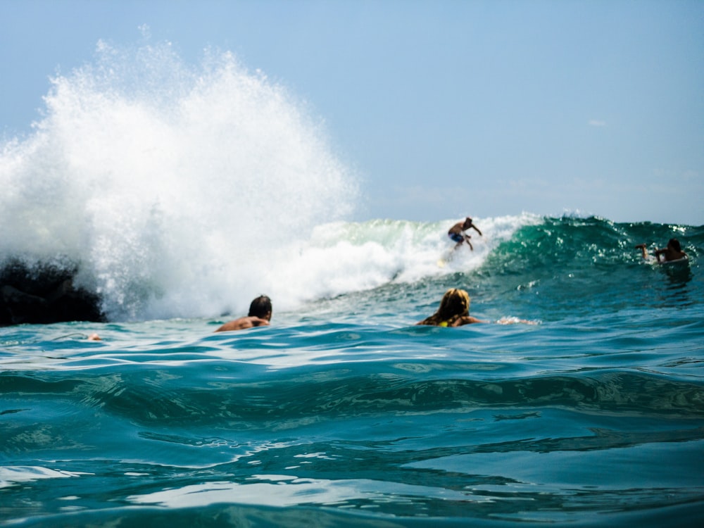 man surfing on sea waves during daytime