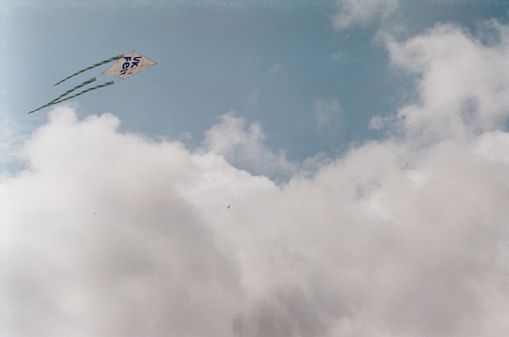 white and blue plane flying in the sky