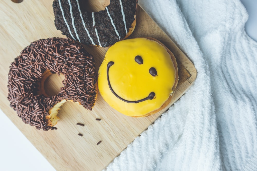 yellow smiley emoji on brown wooden table