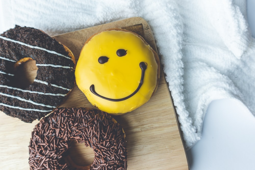 yellow and black smiley emoji pillow