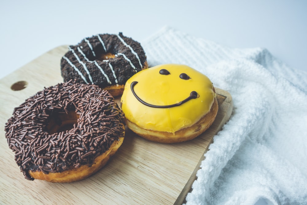 brown and white donut on brown wooden chopping board