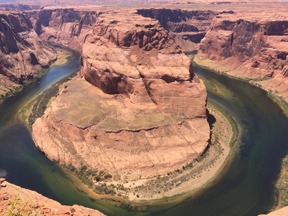 brown rock formation near body of water during daytime