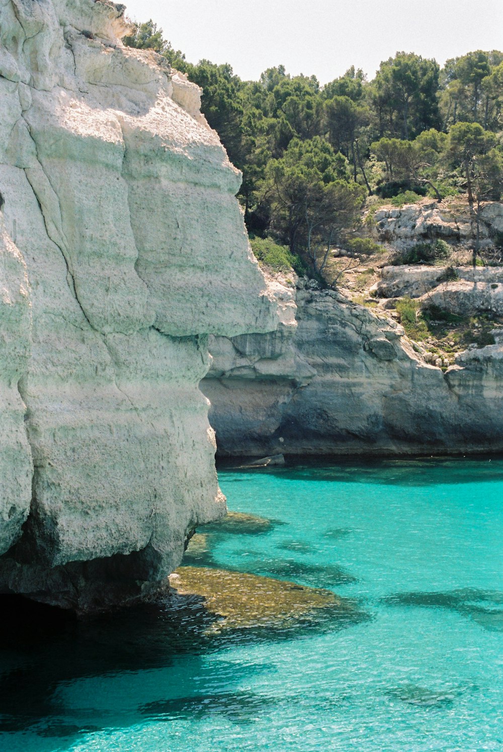 white rock formation beside blue sea during daytime