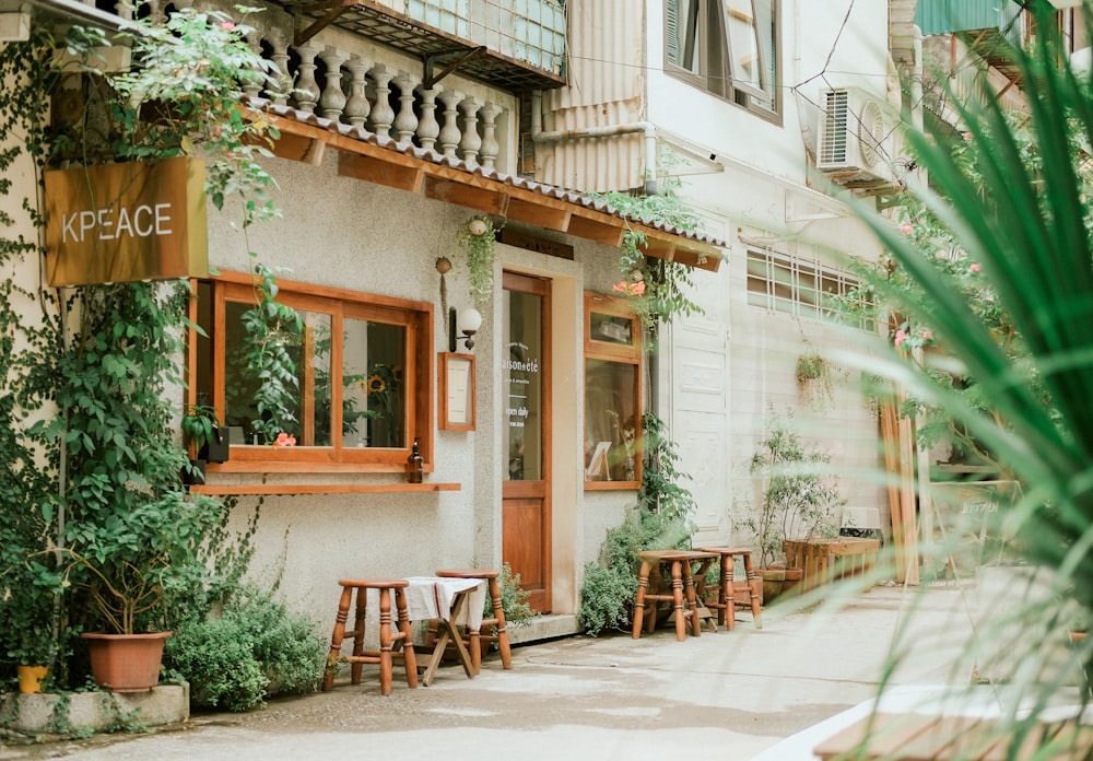 brown wooden chairs and tables outside building during daytime