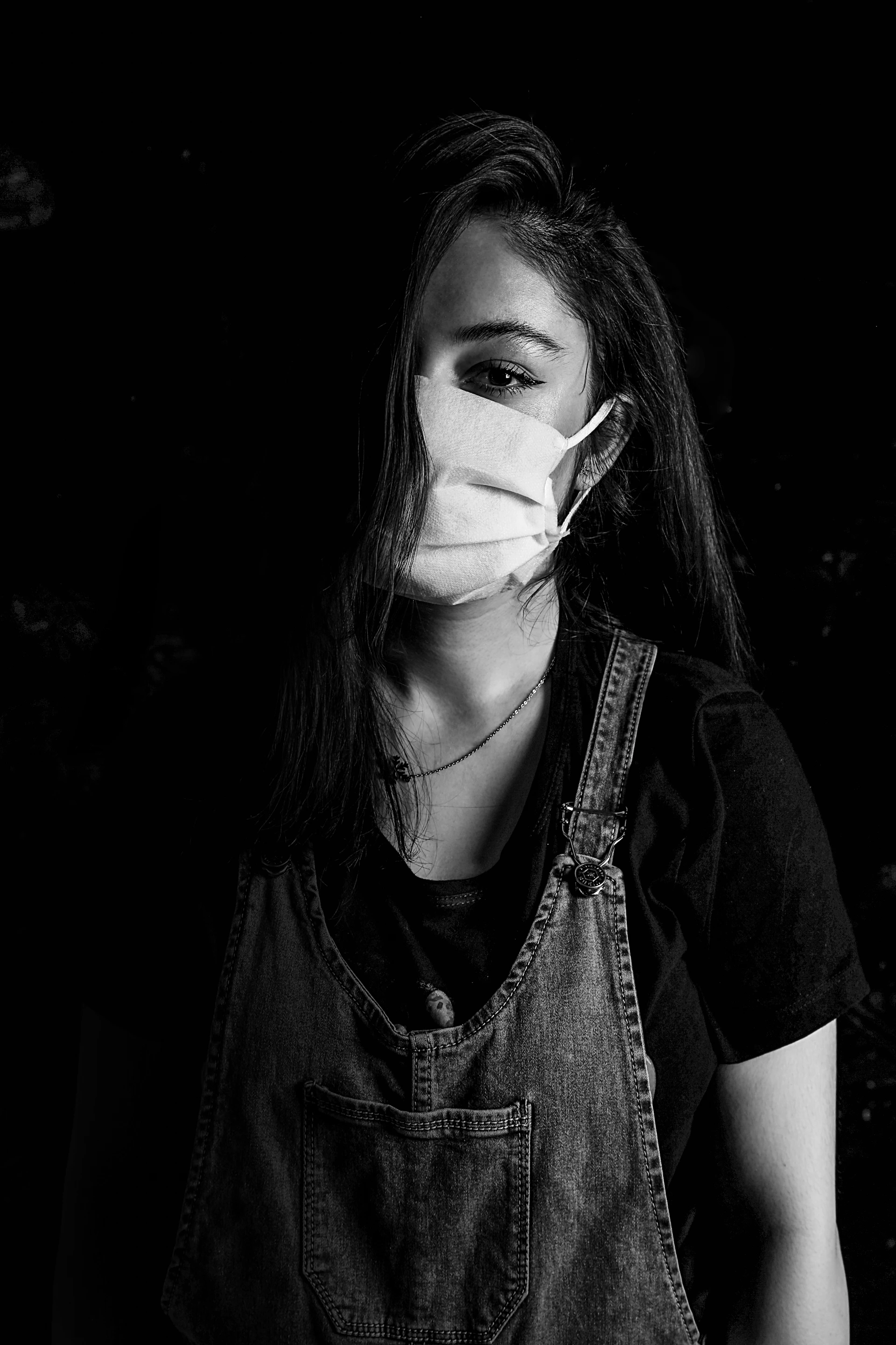 woman in black shirt with white face mask