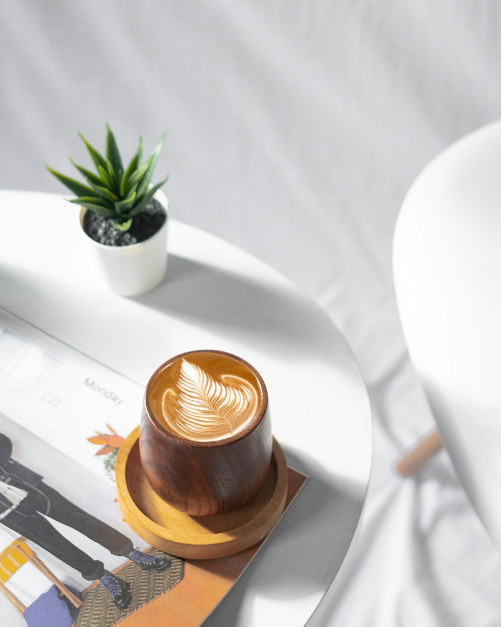 brown ceramic cup on white ceramic plate