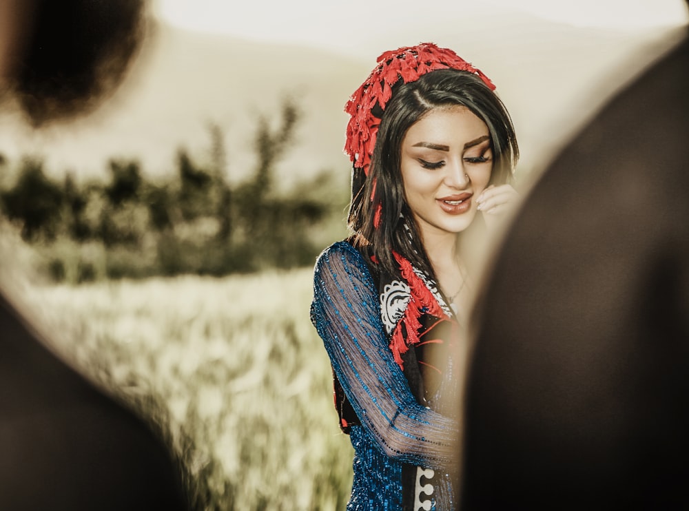 woman in blue denim jacket and red floral headband