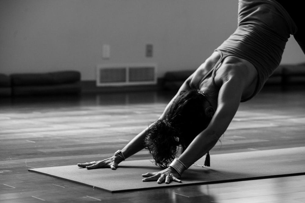 African young woman doing namaste yoga pose - a Royalty Free Stock