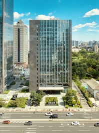 high rise building near green trees and road during daytime