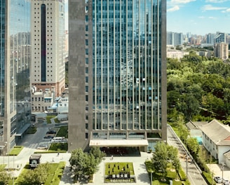 high rise building near green trees and road during daytime