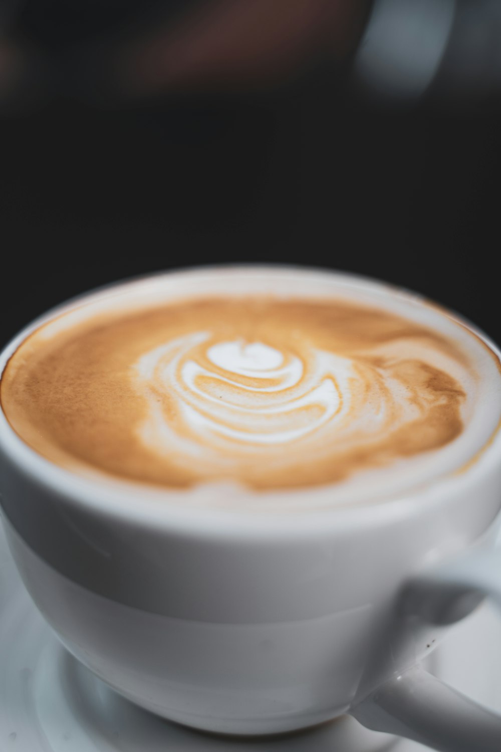 white ceramic mug with brown and white liquid