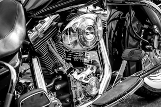 A professional photo of a variety of motorcycle parts neatly arranged on a clean surface.